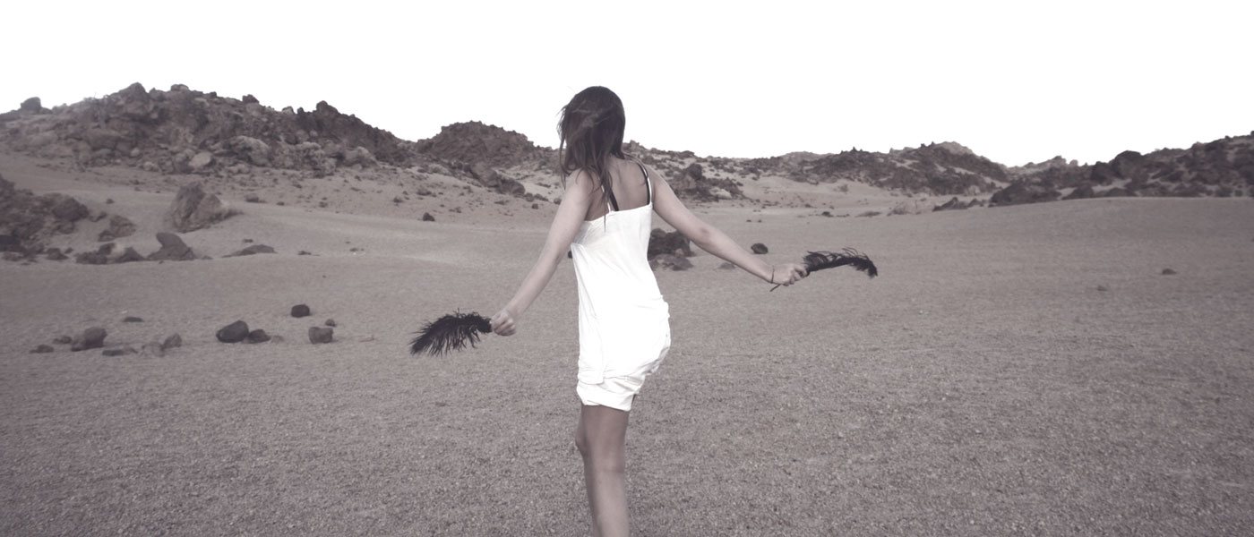 girl baring skin white dress in sand dunes with young skin type