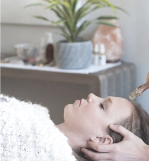 girl laying down have reflexology treatment with dien chan roller tool